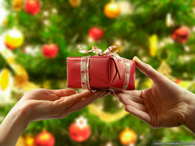Person holding red present christmas free wallpaper for desktop - medium preview image