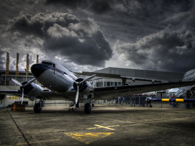 Plane parked tarmac cloudy sky free wallpaper for desktop - medium preview image