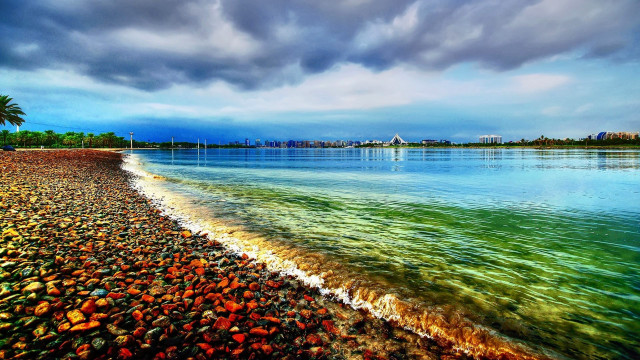 Beach water cloudy sky city free wallpaper for desktop - medium preview image