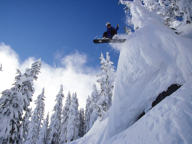 Snowboarder jumping snowy mountain air free wallpaper for desktop - medium preview image