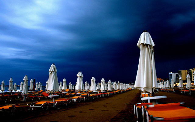 Beach chairs umbrellas cloudy night free wallpaper for desktop - medium preview image