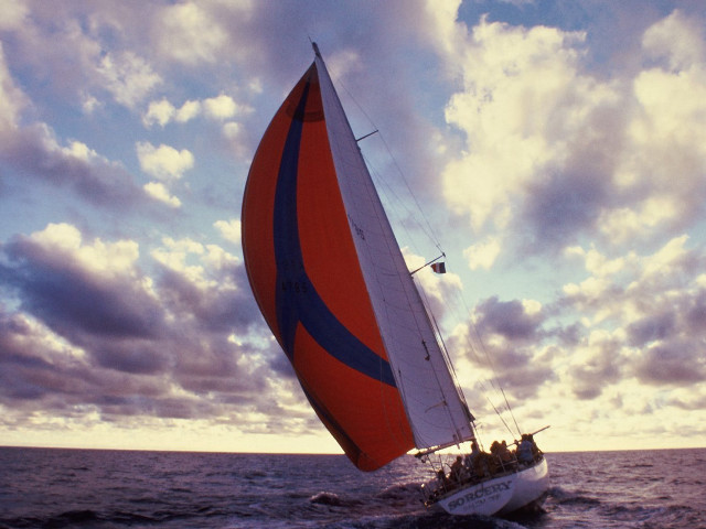 Sailboat red blue sail cloudy free wallpaper for desktop - medium preview image