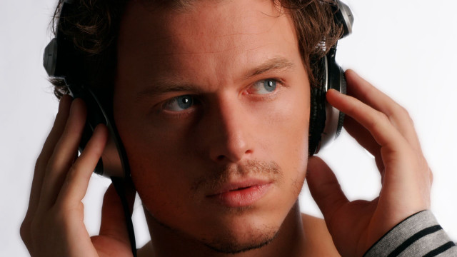 Man headphones serious look camera free wallpaper for desktop - medium preview image