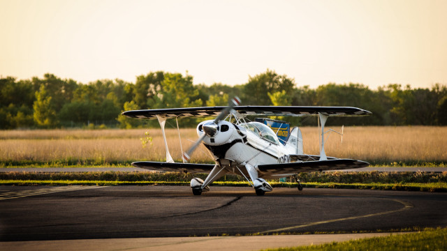 Small plane parked runway grass free wallpaper for desktop - medium preview image