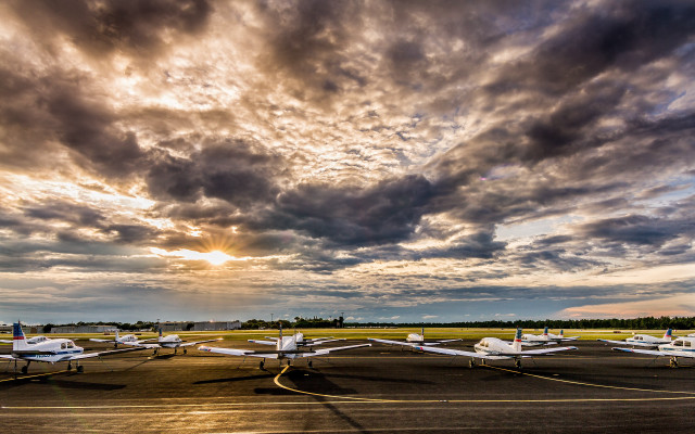 Small planes parked runway cloudy free wallpaper for desktop - medium preview image