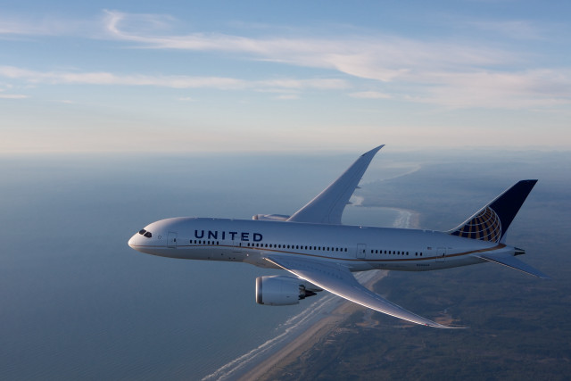 United airplane over ocean sunny free wallpaper for desktop - medium preview image