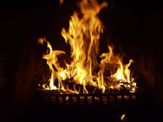 Blazing fireplace bright yellow flames - a fireplace free wallpaper for desktop