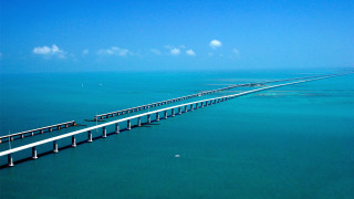 Long bridge spanning ocean blue - aerial free wallpaper