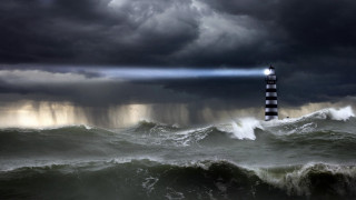 Lighthouse storm ocean light beam - a dark sky free wallpaper