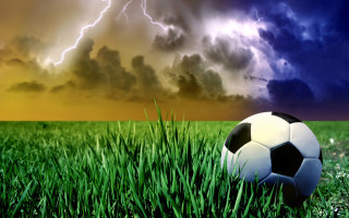 Soccer ball grass storm cloud - a lightning bolt free wallpaper