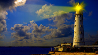 Lighthouse bright light ocean cloudy - yellow light free wallpaper for desktop