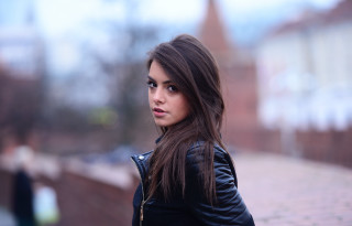 Woman black jacket brick wall - andrea orcagna free wallpaper