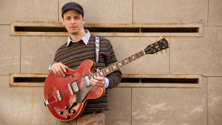 Man holding red guitar wall - ben zoeller free wallpaper