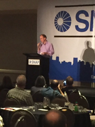 Man standing podium crowd conference - photograph free wallpaper for mobile