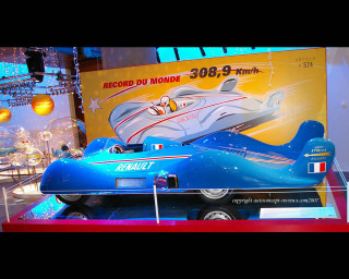 Blue toy car museum case - a sign behind free wallpaper