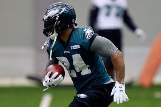 Football player running ball helmet - his hand and a helmet free wallpaper