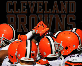 Football players orange helmets cleveland - a group of football players free wallpaper
