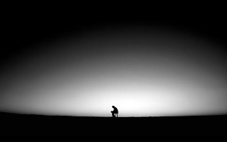 Sunset field person distant silhouette - the sun behind them free wallpaper