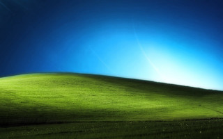 Green field blue sky bright - a bright sun in the sky above free wallpaper