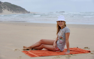 Woman beach towel smiling camera - a towel free wallpaper