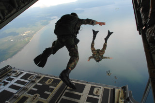 Camouflage man jumps plane water - a plane free wallpaper