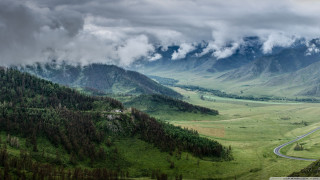 Valley winding road mountains cloudy - a scenic view of a valley free wallpaper