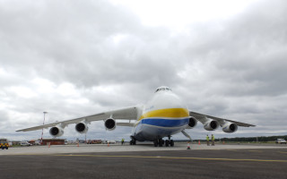 Jetliner airport tarmac cloudy sky - side profile free wallpaper