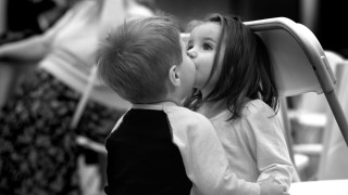Boy girl kissing black white 2 - a woman in the background free wallpaper
