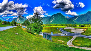 Scenic road mountains blue sky 2 - a green field free wallpaper for desktop