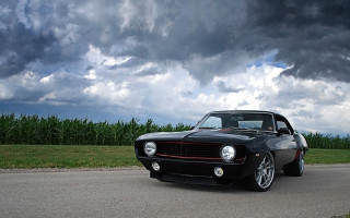 Black muscle car cloudy sky - a black muscle car free wallpaper