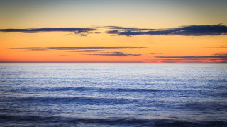 Sunset ocean boat clouds water - a sunset over the ocean free wallpaper