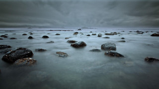 Rocks beach cloudy sky background - top of a beach under a cloudy sky free wallpaper