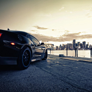 Black sports car water city - city background free wallpaper for tablet