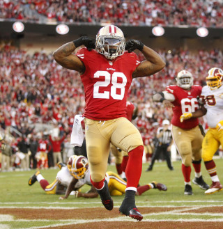 Football player running field helmet - free sports wallpaper for tablet