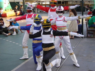 Costumed people sidwalk arms raised - their arm free wallpaper