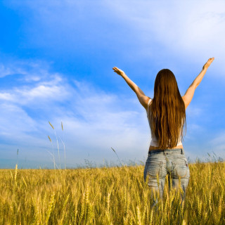 Woman standing field tall grass - free summer wallpaper for tablet