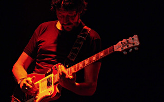 Man playing guitar dark room 2 - a man playing free wallpaper