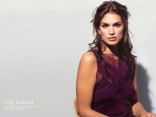 Woman sitting chair arms crossed - a gold bracelet free wallpaper