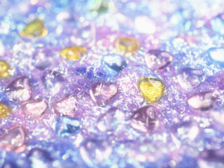 Colored stones closeup blurry background - a table top free wallpaper