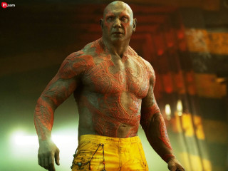 Tattooed man yellow shorts dark - a spotlight free wallpaper