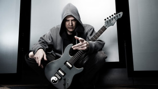 Man hoodie guitar pointing camera - his finger free wallpaper