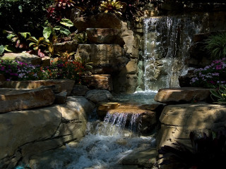 Waterfall garden rocks flowers bench - a bench in the background free wallpaper