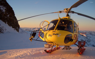 Yellow helicopter snow mountain sunset - top of a snow free wallpaper