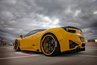 Yellow sports car red stripe 4 - a parking lot under a cloudy sky free wallpaper