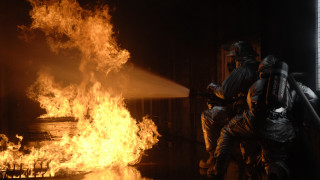 Fireman spraying water building flames - water free wallpaper for desktop
