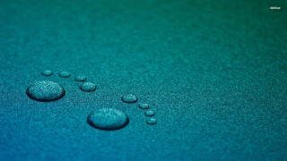 Water droplets blue surface macro 2 - a close up of water droplets free wallpaper