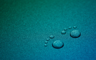 Water droplets blue surface green 2 - a close up of water droplets free wallpaper for desktop