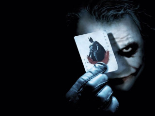 Man holding joker card knife 2 - a card free wallpaper