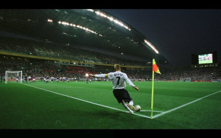 Soccer player kicking night stadium - a soccer ball free wallpaper