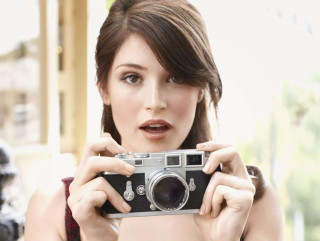 Woman holding camera surprised expression - expression free wallpaper